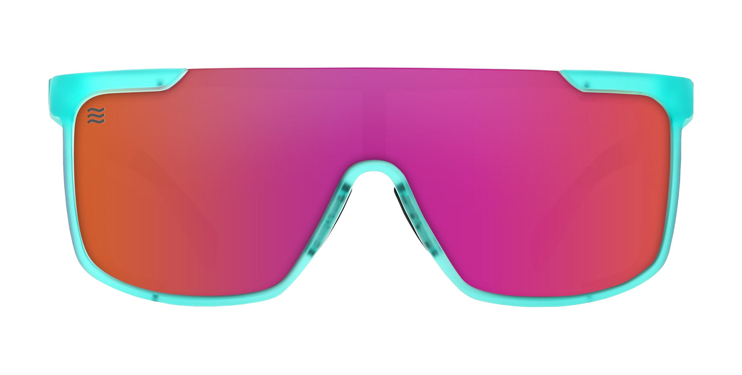 The Neven Eyewear T.D.K. sunglasses feature a large, single-lens design with a turquoise blue frame and gradient magenta-to-orange lens. These sporty, wraparound polarized shades display a wave logo on the upper left of the lens. White background.