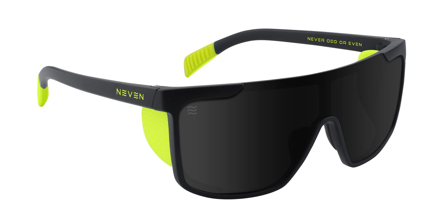 Matte black Whistler sunglasses by Neven Eyewear with large wraparound dark lenses, neon yellow accents, polarized UV400 protection, NEVEN on one arm, and NEVER ODD OR EVEN printed inside the frame near the temple.