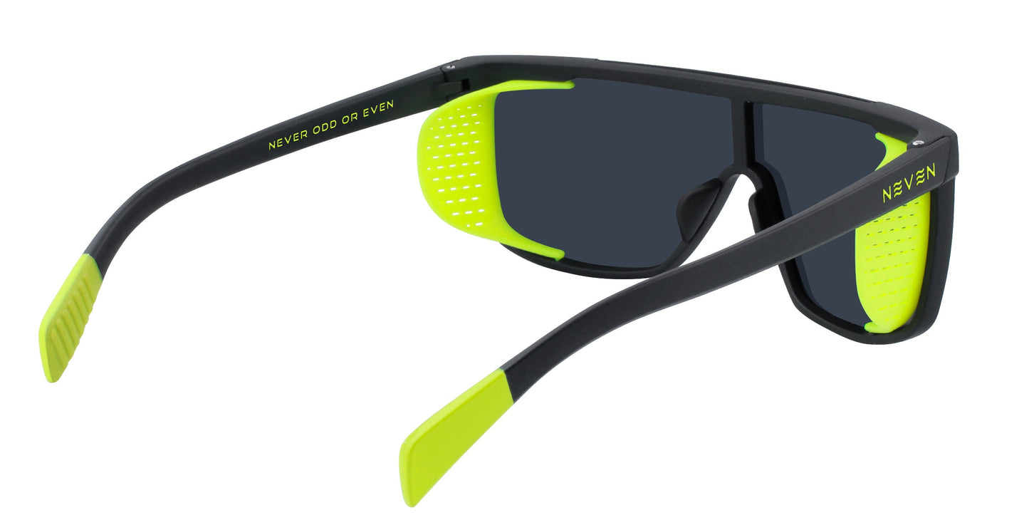 The Neven Eyewear Whistler sunglasses feature a black frame, dark lenses, neon yellow inner arms with textured grips, NEVEN and NEVER ODD OR EVEN text on the arms, and removable side shields for polarized UV400 protection.