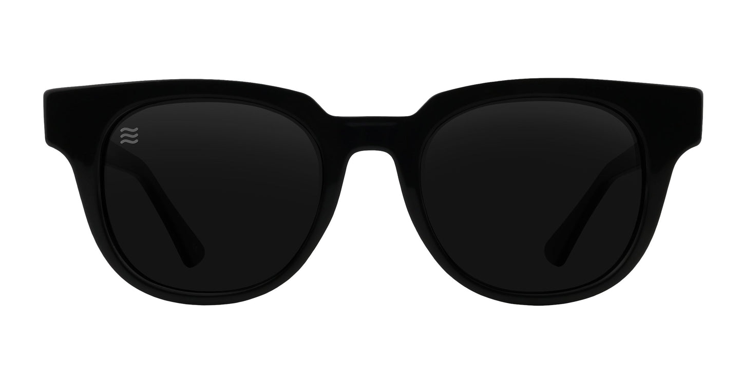 The Neven Eyewear Cerberus sunglasses feature full black rims, wide frames, dark rectangular UV400 lenses, and a white wave logo on the upper left lens—all displayed against a white background.