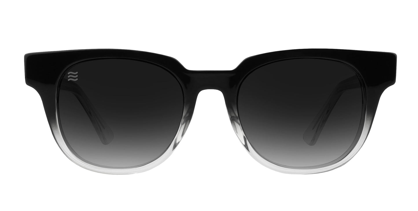 The Neven Eyewear Fang sunglasses feature thick, square gradient frames fading to clear at the bottom and dark polarized UV400 lenses that lighten toward the base, shown from the front against a white background.