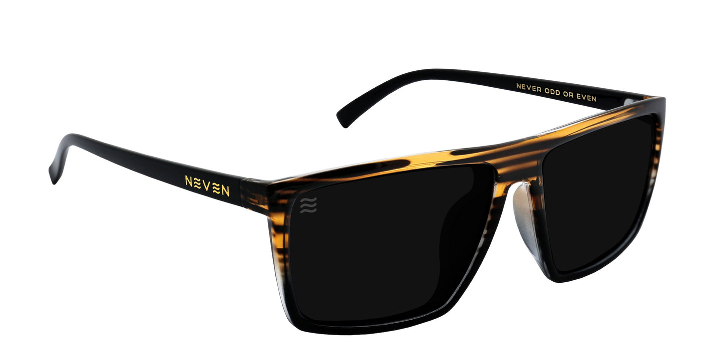 Asbury XL sunglasses by Neven Eyewear feature a thick, black wood-grain rectangular frame with brown tortoiseshell accents and polarized lenses. Temples are black with gold NEVEN text and NEVER ODD OR EVEN printed inside on white.