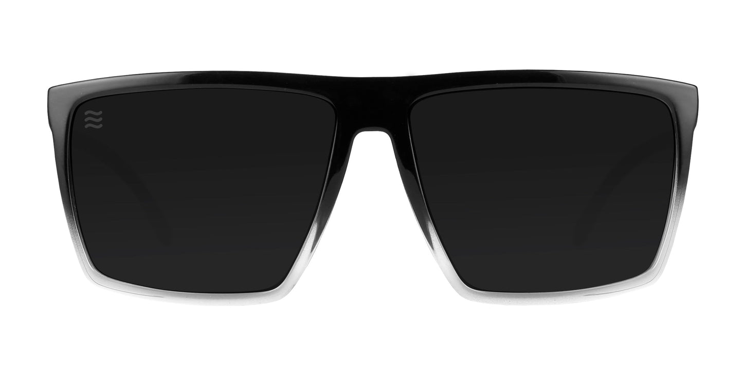 The Colorado Bulldog by Neven Eyewear features large, rectangular polarized lenses with UV400 protection, a bold flat-top black frame that fades to clear at the bottom, and a subtle wave logo on the upper left lens.