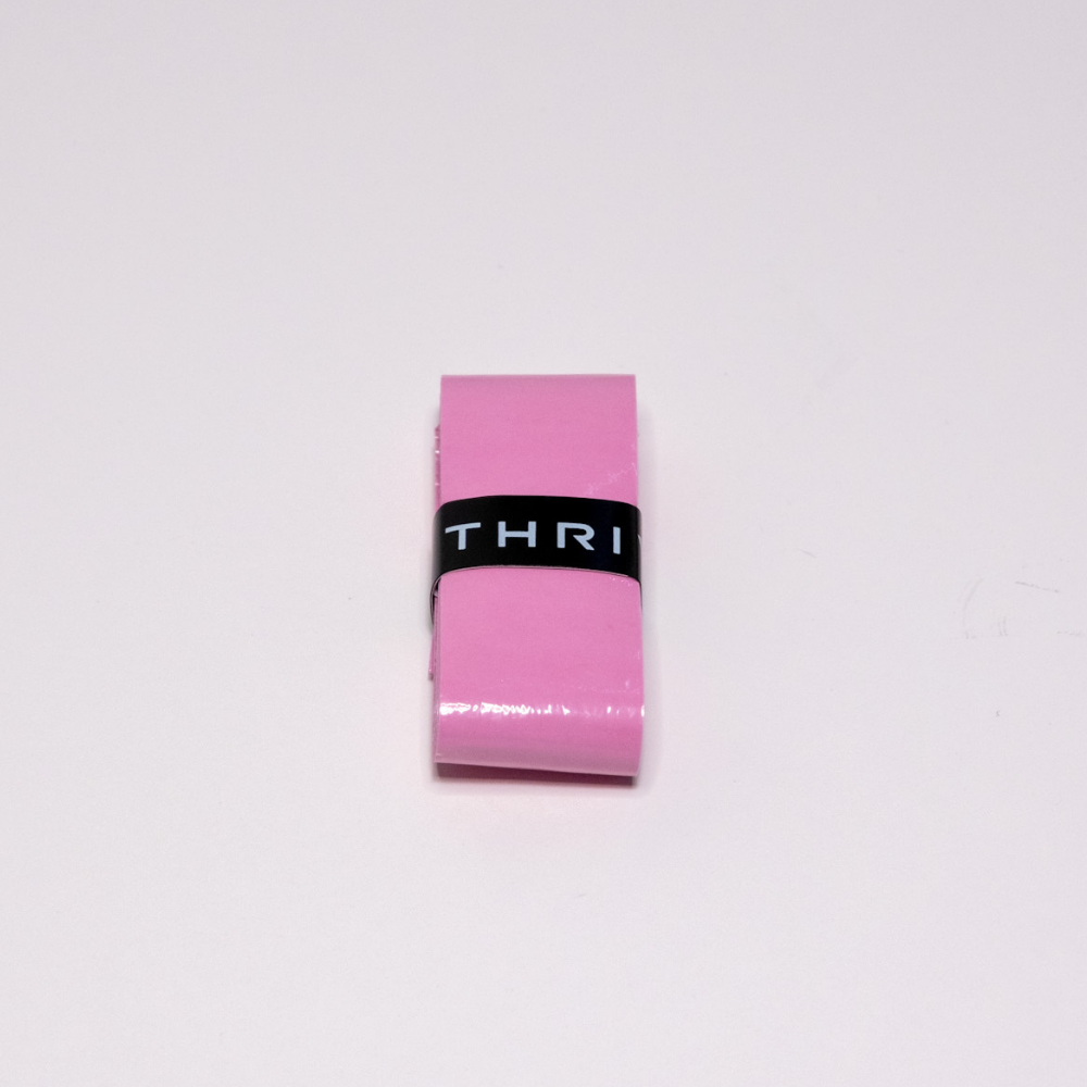A smooth, glossy rectangular pink eraser with a Thrive Pickleball Overgrips (Super Tacky)-inspired black band reading "THRI" is centered on a plain white background, reflecting the super tacky and durable qualities of the product.