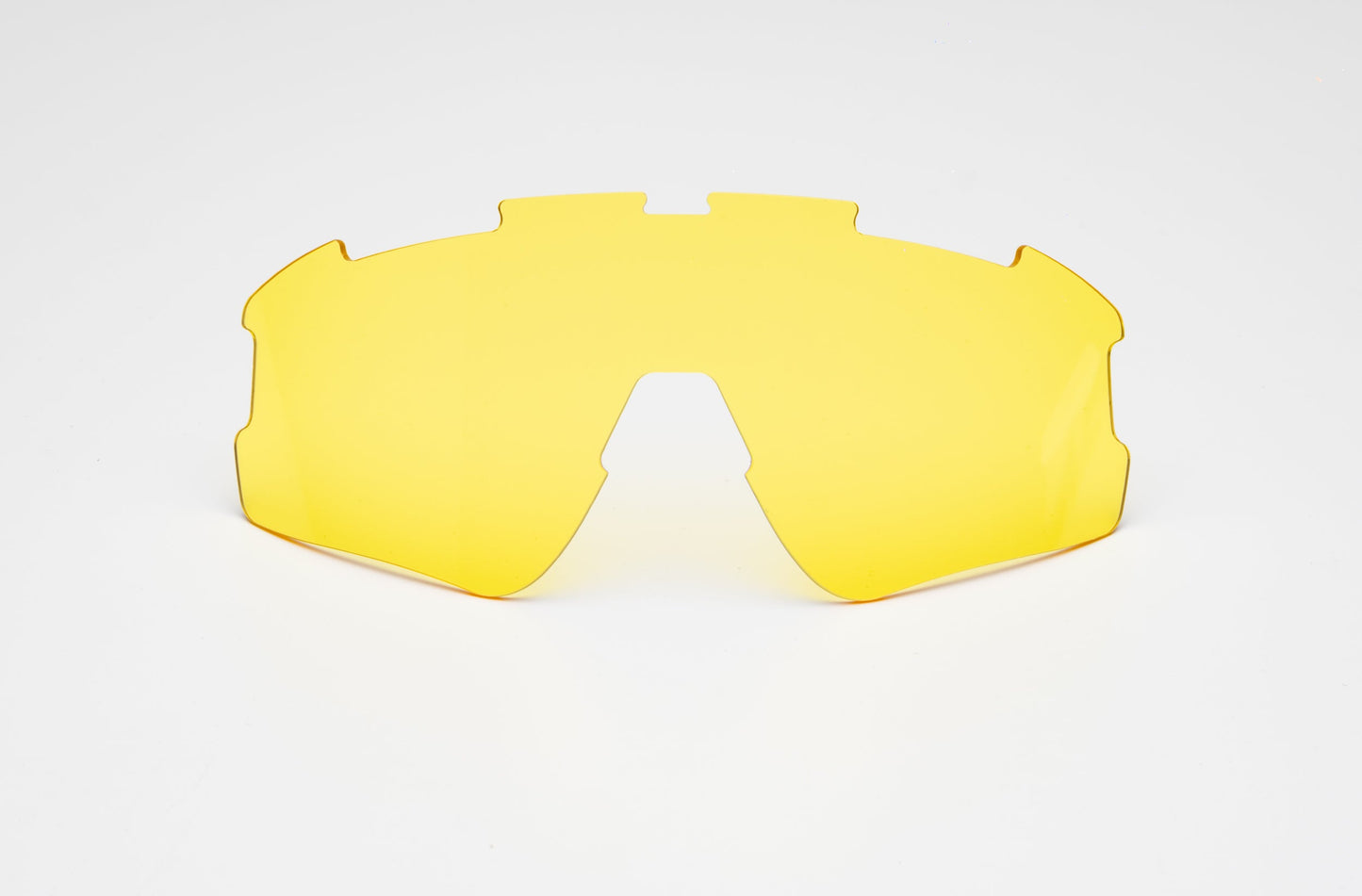 The Thrive Pickleball Additional Lens Color is a curved, yellow-tinted sports sunglass lens with angular edges and a nose cutout, shown on a white background. It’s designed for pickleball sunglasses and provides dependable UV protection.