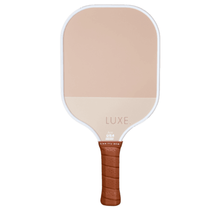 The Dipped - Ace paddle by LUXE Pickleball features a beige, rounded rectangular face, brown textured grip, and "LUXE" above the handle with "USA" and "kiss my ace" below—ideal for pickleball fans.