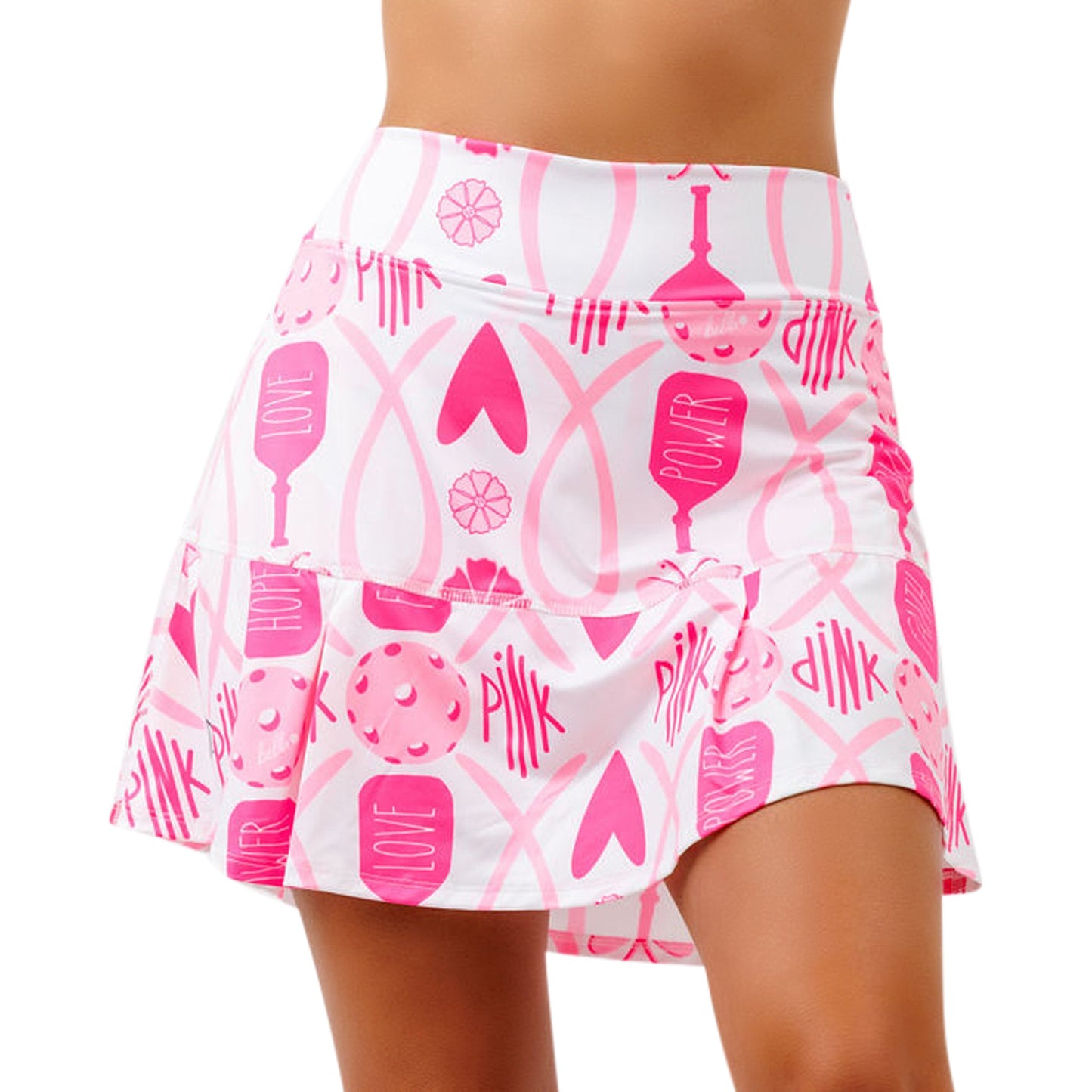 A woman models the Pickleball Bella PB Drop Pleat Skort Hope—a white high-waist mini skort with a flared hem, decorated with all-over heart, LOVE, PINK, POWER prints, and abstract shapes. Only her torso and thighs are shown.