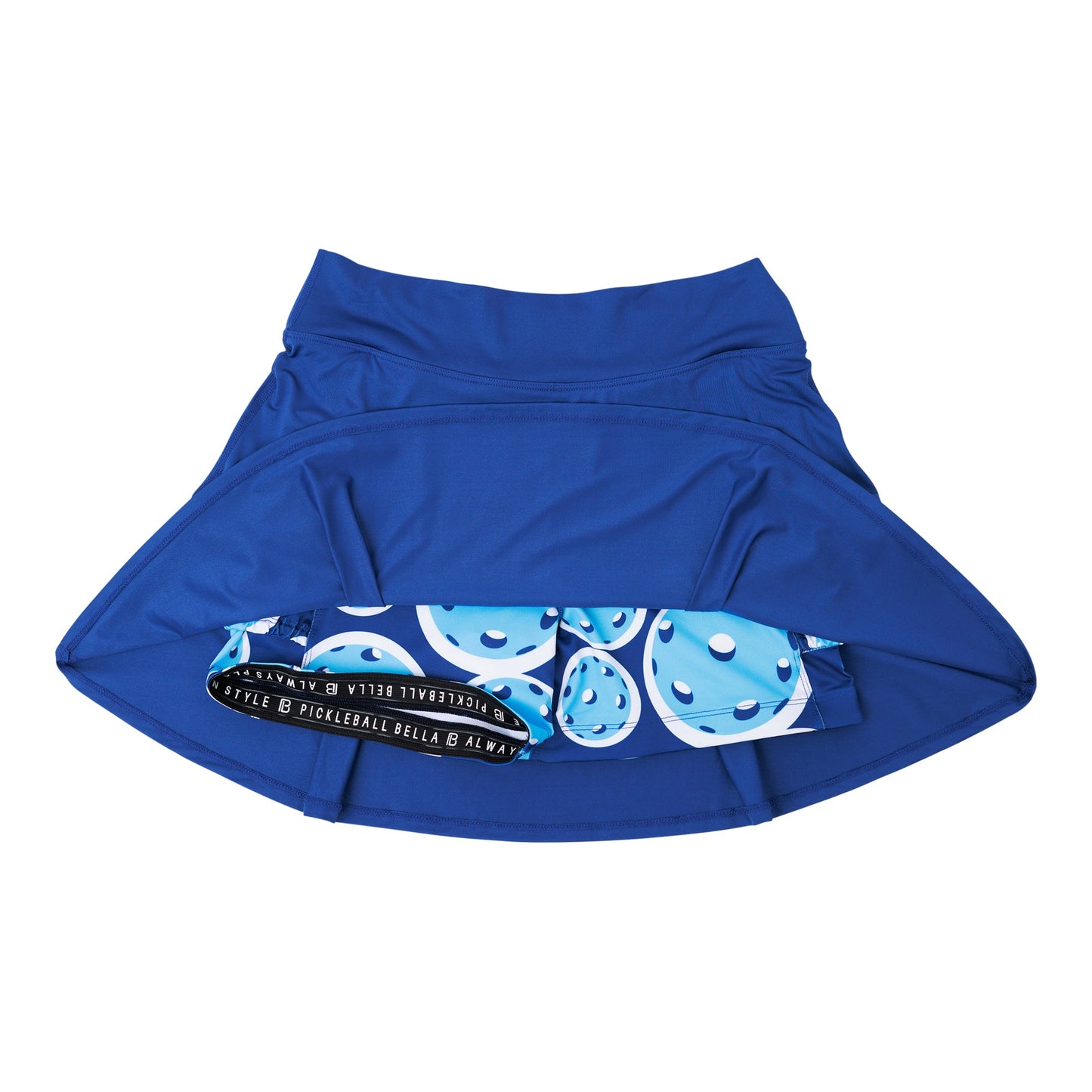 The Pickleball Bella PB Drop Pleat Skort Navy with Double Bounce is shown inside out, displaying its inner blue pickleball-patterned compression shorts and wide waistband. Made of smooth, stretchy fabric, it's ideal for sports. White background.