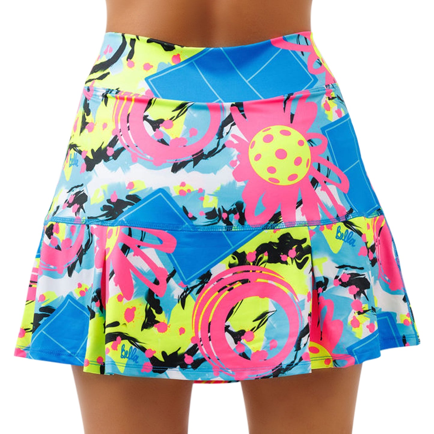 A close-up of a woman wearing the Pickleball Bella PB Drop Pleat Skort Open Play. The vivid abstract pattern pops against the white backdrop, and the comfortable waistband ensures a perfect fit. Only her lower torso and upper legs are shown.