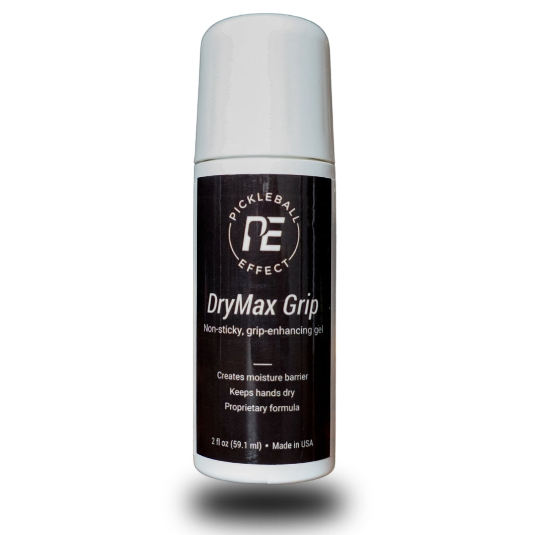 A small, upright bottle of Pickleball Effect Shop’s DryMax Grip hand gel features a black label with white text promoting sweat control and enhanced grip; 2 oz (59.1 mL), made in the USA, with a soft shadow below.