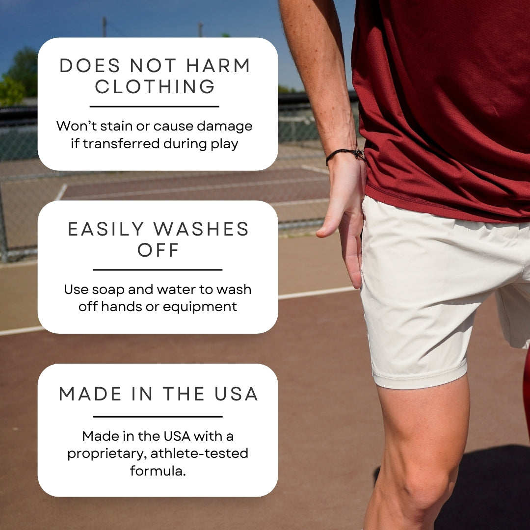 A person in athletic maroon shirt and white shorts stands on an outdoor court. Text boxes highlight “Enhanced grip control,” “Easily washes off,” and “Made in the USA” for DryMax Grip by Pickleball Effect Shop, a safe, athlete-tested hand grip gel.