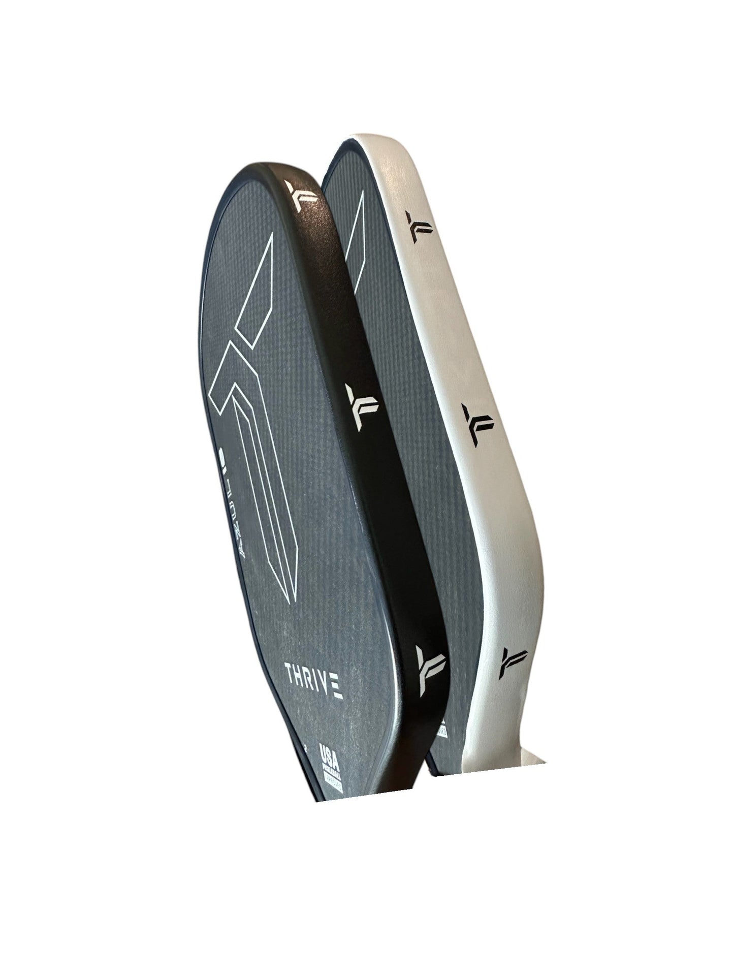 Two modern pickleball paddles stand upright side by side, featuring minimalist designs and protected by Thrive Pickleball’s Edge Guard Tape (2 pcs), which adds durable edge protection.