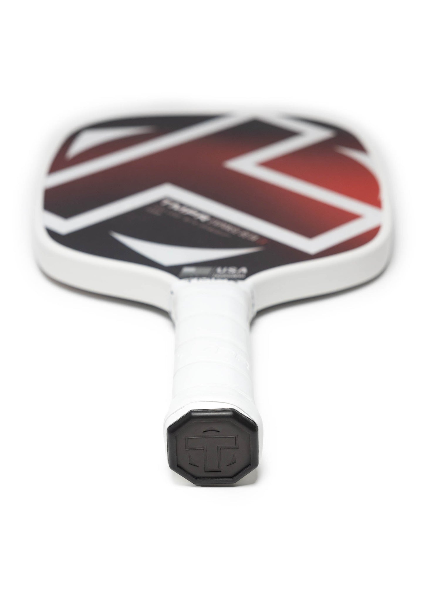 The TMPR Sports Expanse Beta LX is a white hybrid pickleball paddle with a black grip, featuring a bold black-and-red geometric fiberglass face and an embossed hexagonal logo cap. Paddle lies flat on a plain white background, handle facing forward.