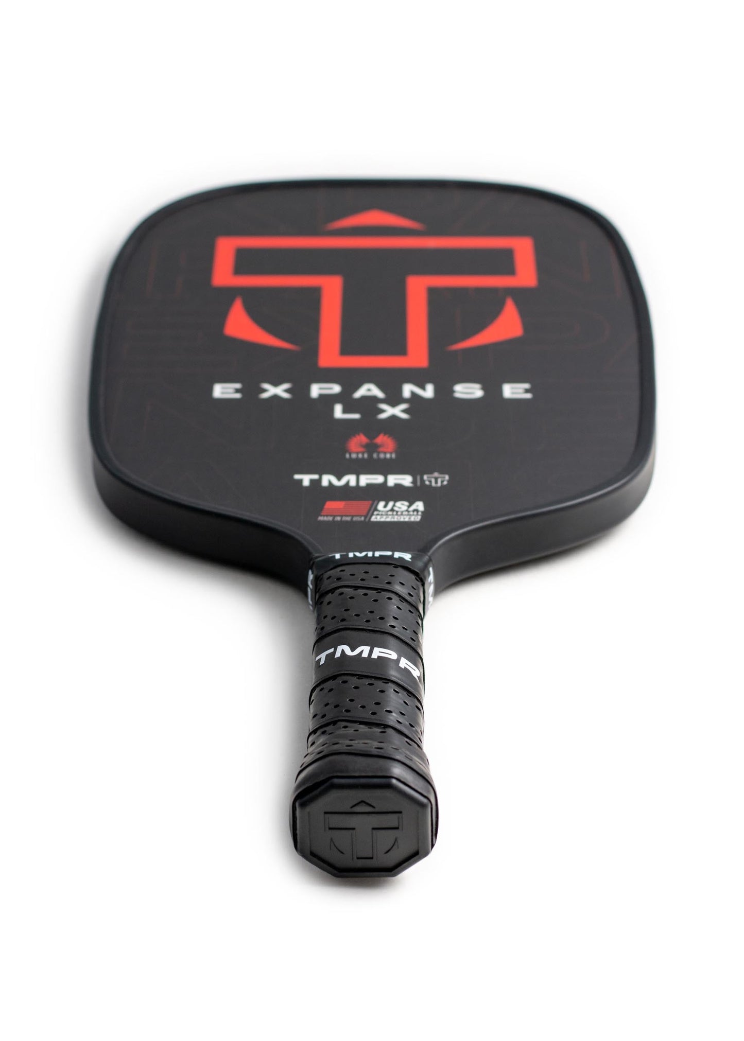 The Expanse LX by TMPR Sports is a black widebody paddle with a large red T logo and "EXPANSE LX" text on its fiberglass face, a wrapped TMPR-branded grip, and a honeycomb polypropylene core, shown on a white background.