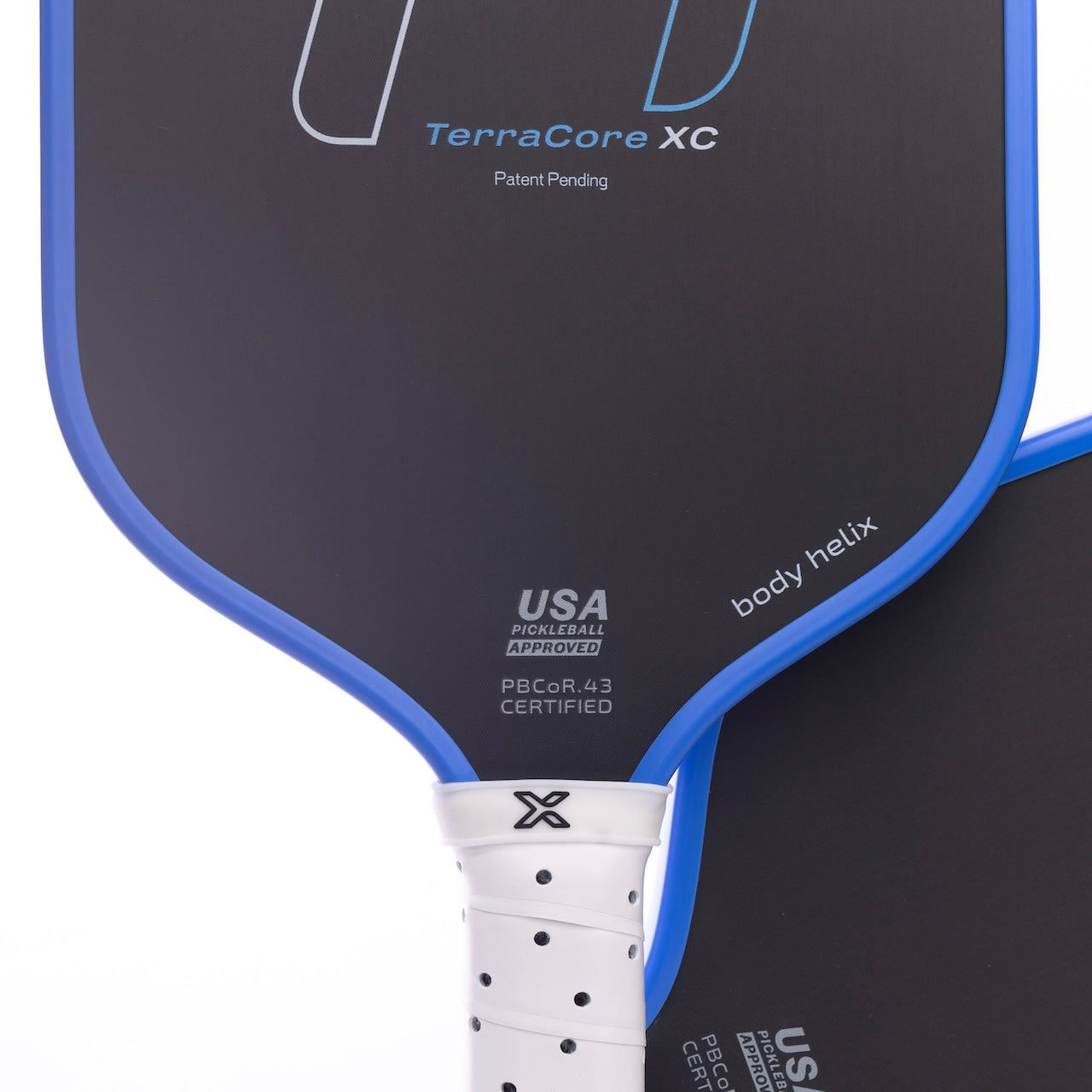 Close-up of two FLiK F1 Elongated Pickleball Paddles by body helix, with black faces and blue edges. The USAP-approved paddle in front features a white grip and PBORG43 Certified mark near the bottom.