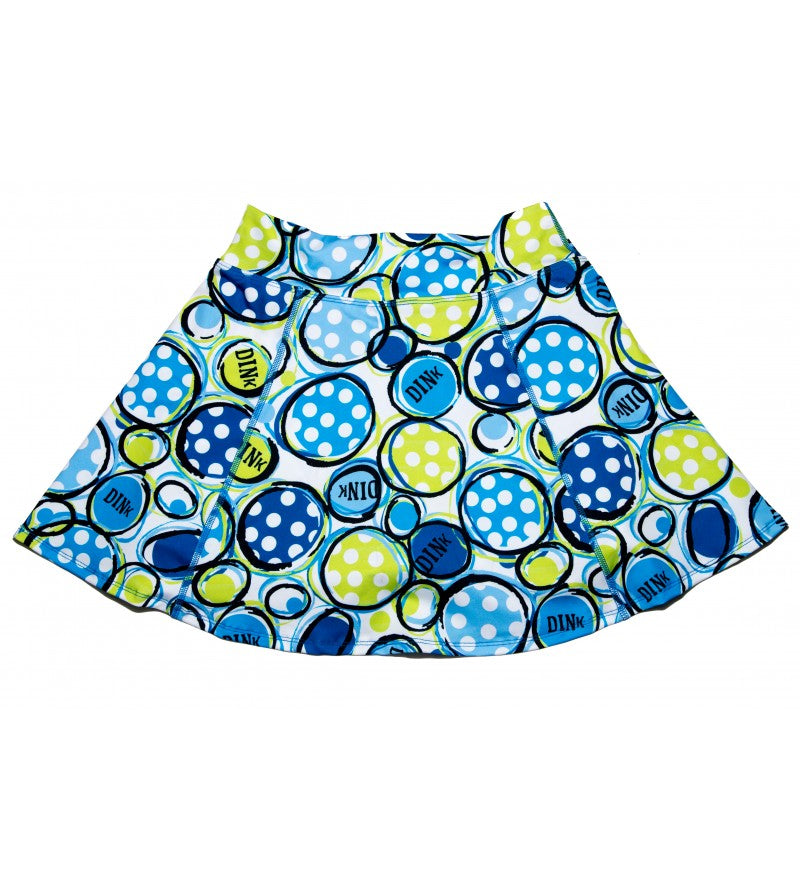 The PB Aline Skort Dink 1 by Pickleball Bella features a flared design with blue, green, and yellow tennis balls—some with "DINK"—on a white background. Its elastic waistband and sporty style make it ideal for tennis or casual wear.