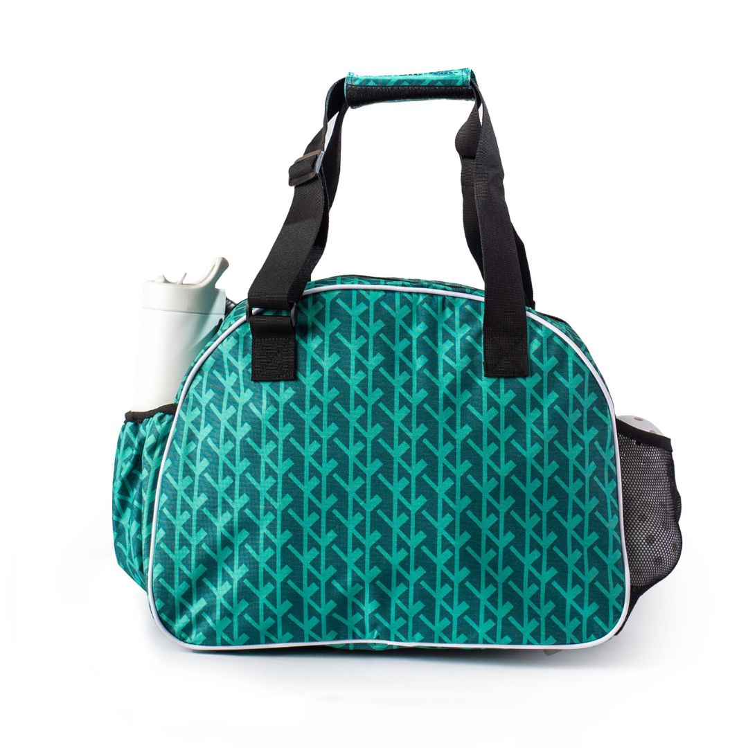 The Pik'le'Ball Sports Court Couture Premium Women's Pickleball Bag features teal and black colors, a geometric arrow pattern, two black handles, top zipper, bottle pocket on the left, mesh pocket on the right, and is shown on a white background.