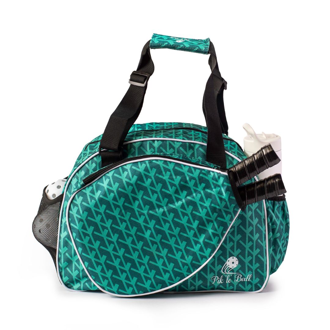 The Court Couture Green Premium Women's Pickleball Bag by Pik'le'Ball Sports features a teal and green V-shaped pattern, black handles, white trim, a mesh pocket for balls, and a front compartment for paddles and water bottles.