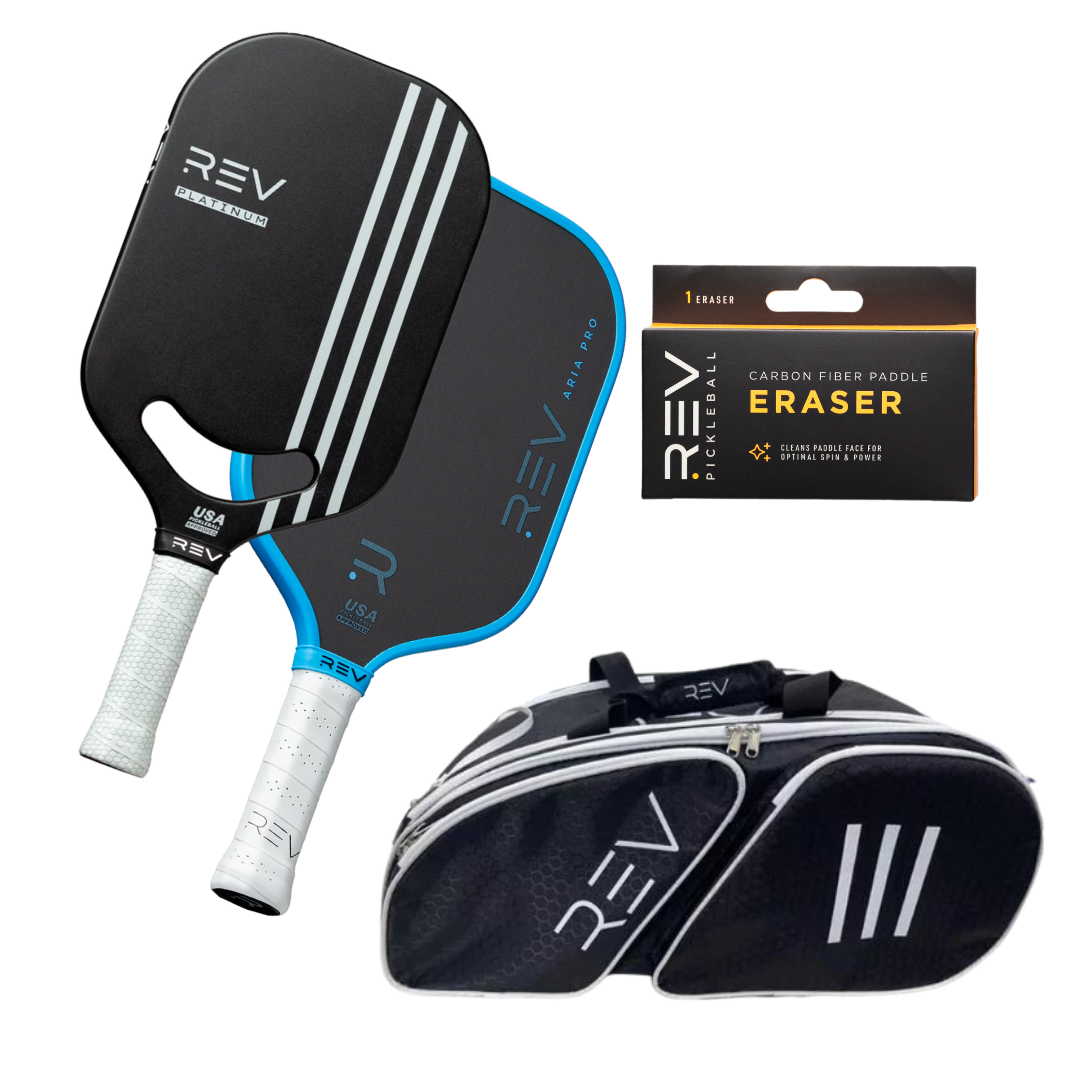 The REV Pickleball Professional - Mix & Match - Bundle for 2 includes two paddles (black with white and blue accents), a paddle eraser in black packaging, and a black and white sports bag with the REV logo and three white stripes.