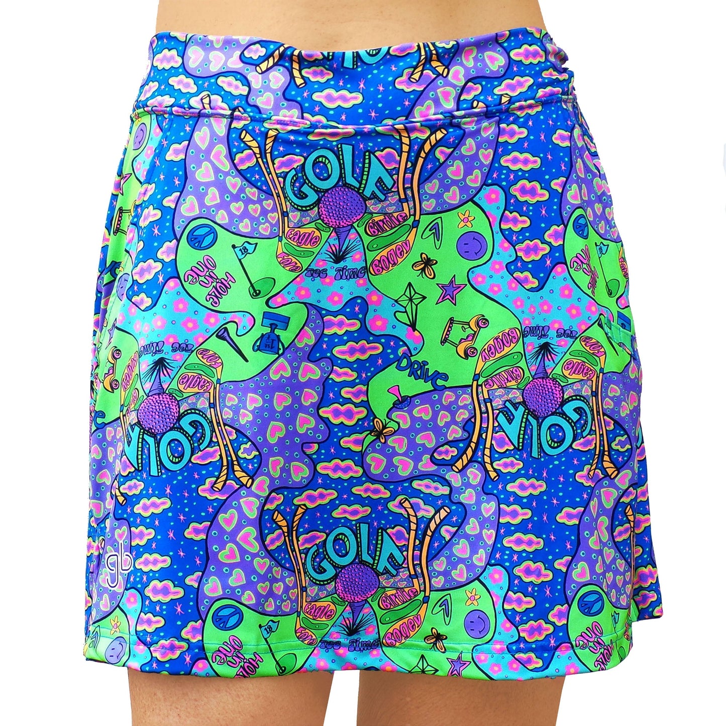 The Pickleball Bella Groovy Straight Golf Skort features mirrored green cartoon cats with pink accents, purple mushrooms, stars, hearts, and peace signs on a blue background with wavy clouds. Shown from waist to mid-thigh.