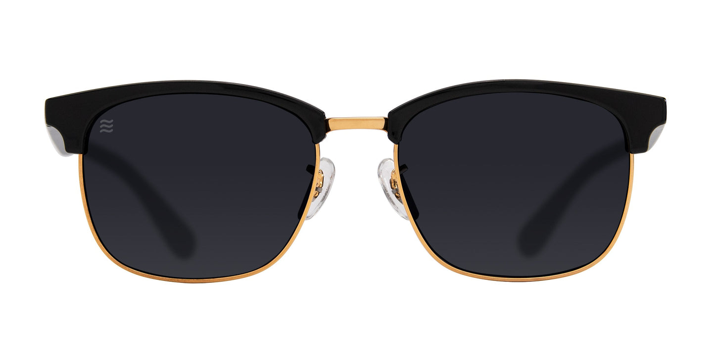The Gold Rush by Neven Eyewear features TR90 sunglasses with black lenses, a gold metal frame topped in black, clear adjustable nose pads, and a modern classic design. These polarized shades offer UV400 protection.