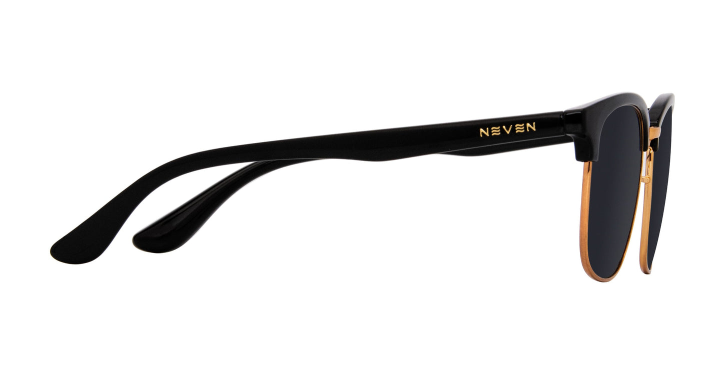 A close-up side view of Neven Eyewear’s Gold Rush TR90 sunglasses shows a gold rim accent, gold NEVEN logo on the temple, glossy frame with curved arms, and dark-tinted polarized UV400 lenses for impact-resistant glare protection.