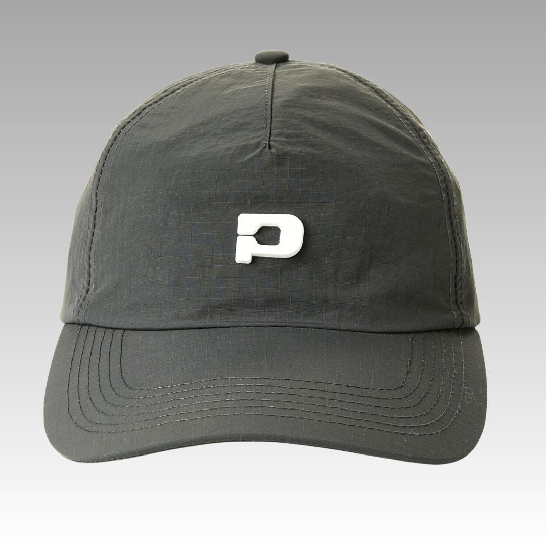 The Hi Hat Pickleball Hat by Playly Store is a dark gray, moisture-wicking ripstop nylon cap with a raised white "P" on the front and detailed stitching on the brim and panels, shown against a light gray gradient background.