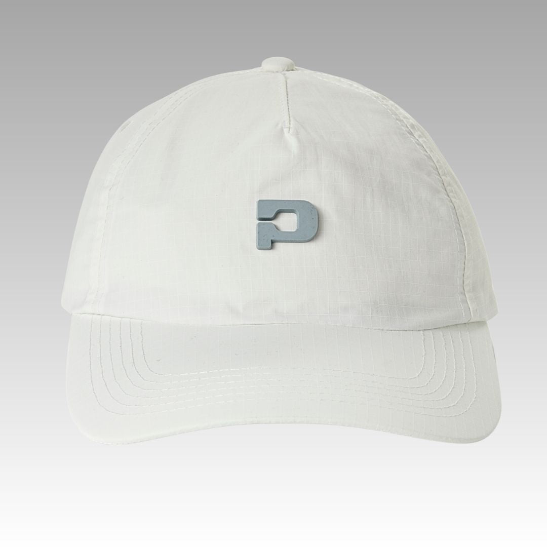 The Hi Hat Pickleball Hat by Playly Store is a white, moisture-wicking ripstop nylon cap with visible stitching, a curved brim, and a raised metallic-gray “P” logo on the front. Shown against a smooth gray gradient background.