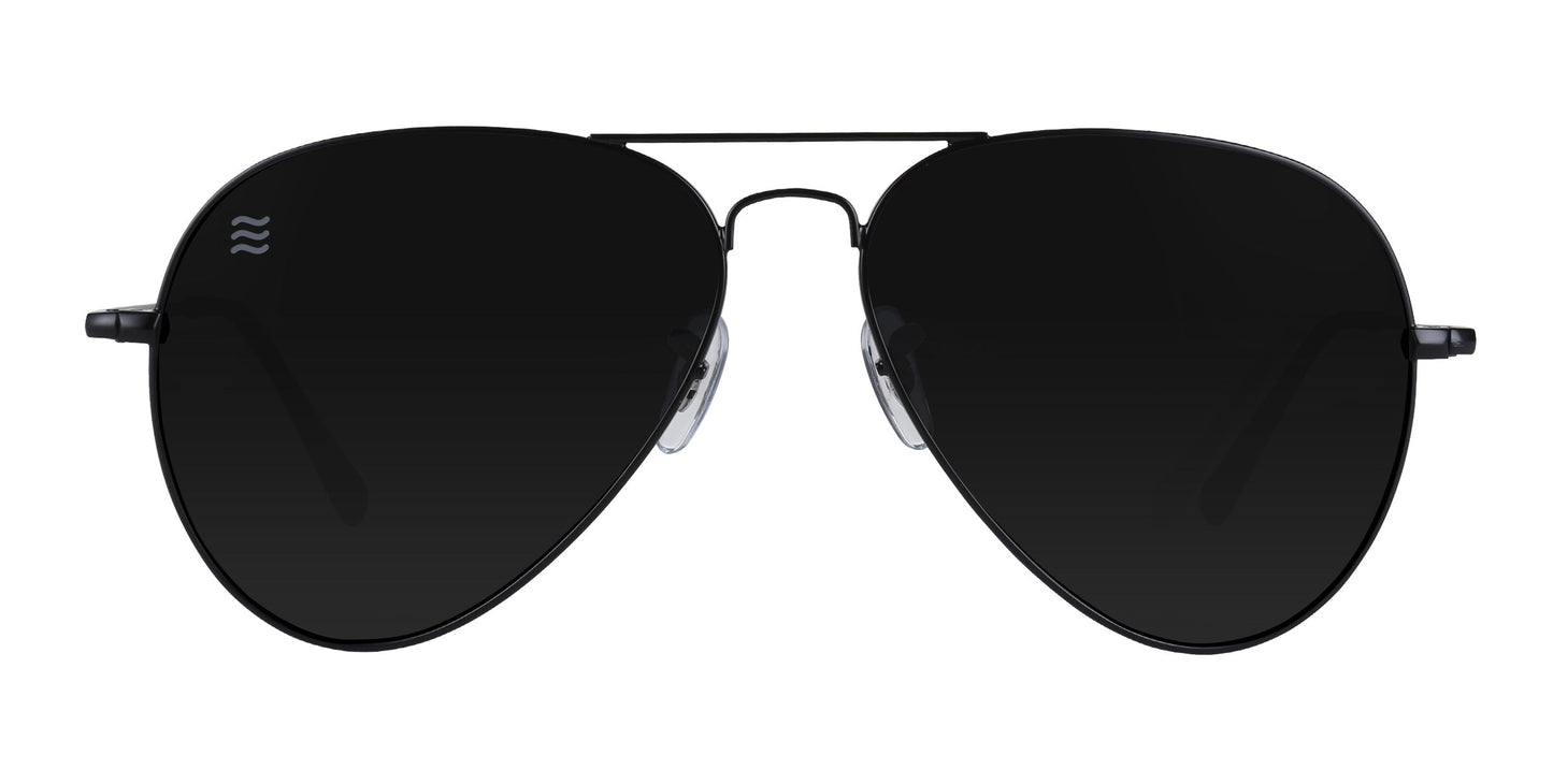 Front view of Neven Eyewear’s Nightfall black aviator sunglasses with large, impact-resistant polarized lenses, thin black metal frames, clear nose pads, and a small white wave logo on the left lens. Offers UV400 protection. Plain white background.