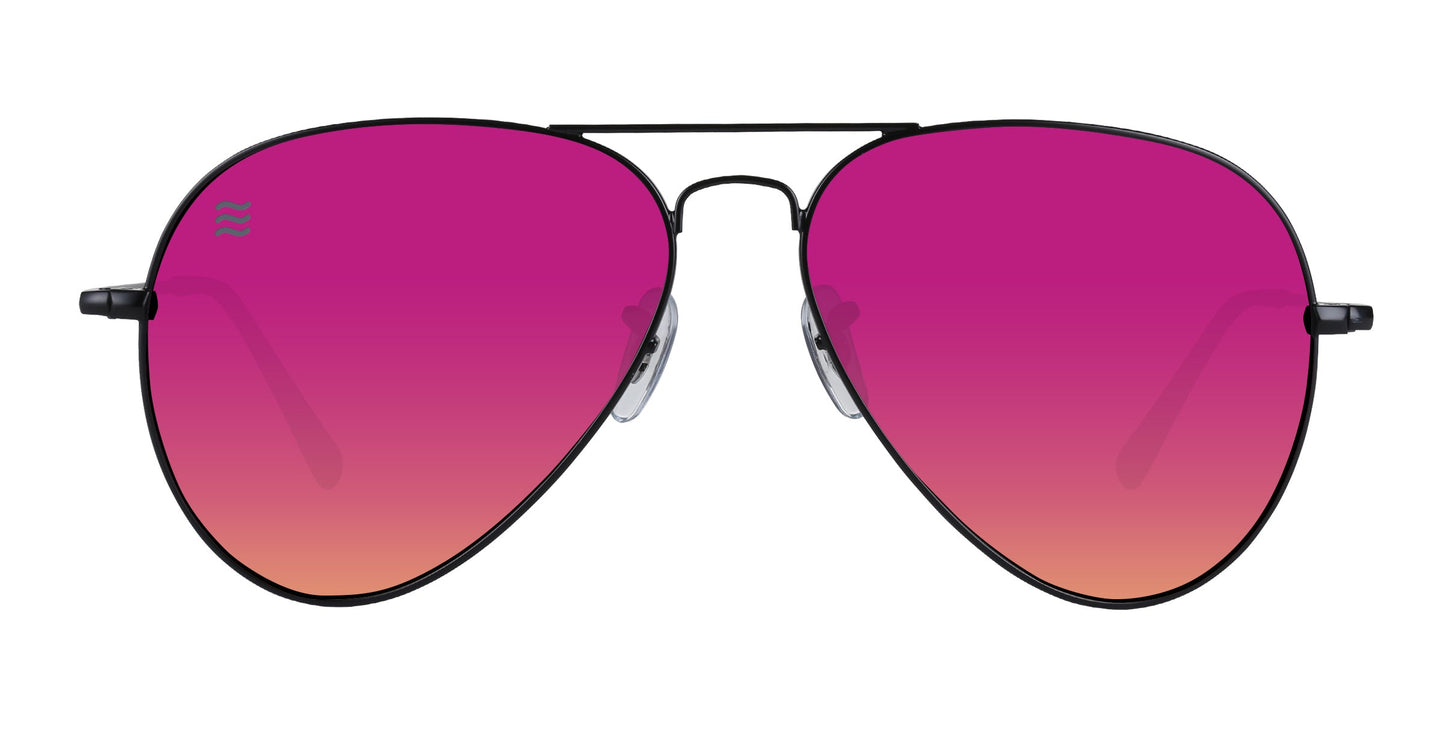 The Space Coast by Neven Eyewear features thin stainless steel frames, large teardrop lenses with a pink-to-orange gradient, small nose pads, double bridge design, and UV400 protection. Set against a plain white background.