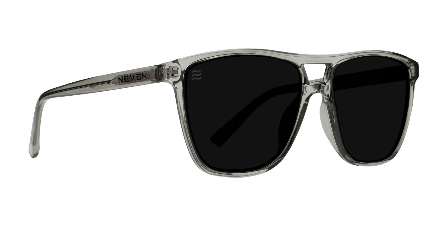 Rip Tide by Neven Eyewear: Clear gray rectangular sunglasses with large black polarized lenses, UV400 protection, a glossy transparent frame, and NEVEN printed near the hinge—perfect for sunny days in Indian Harbor Beach.