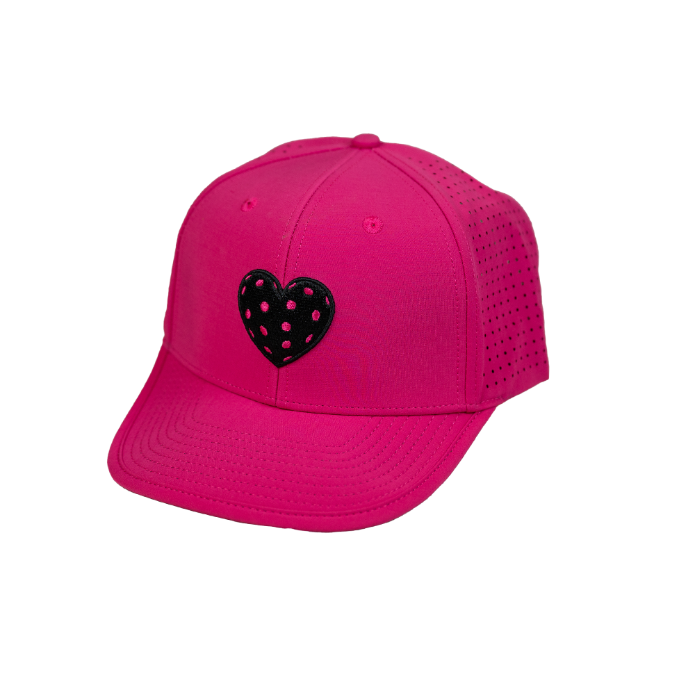 The SEXY Brand I ❤️ Pickleball AquaSnapBack in Hot Pink features a black heart patch with white polka dots, curved brim, and ventilated sides—ideal for Pickleball. Shown on a plain white background.