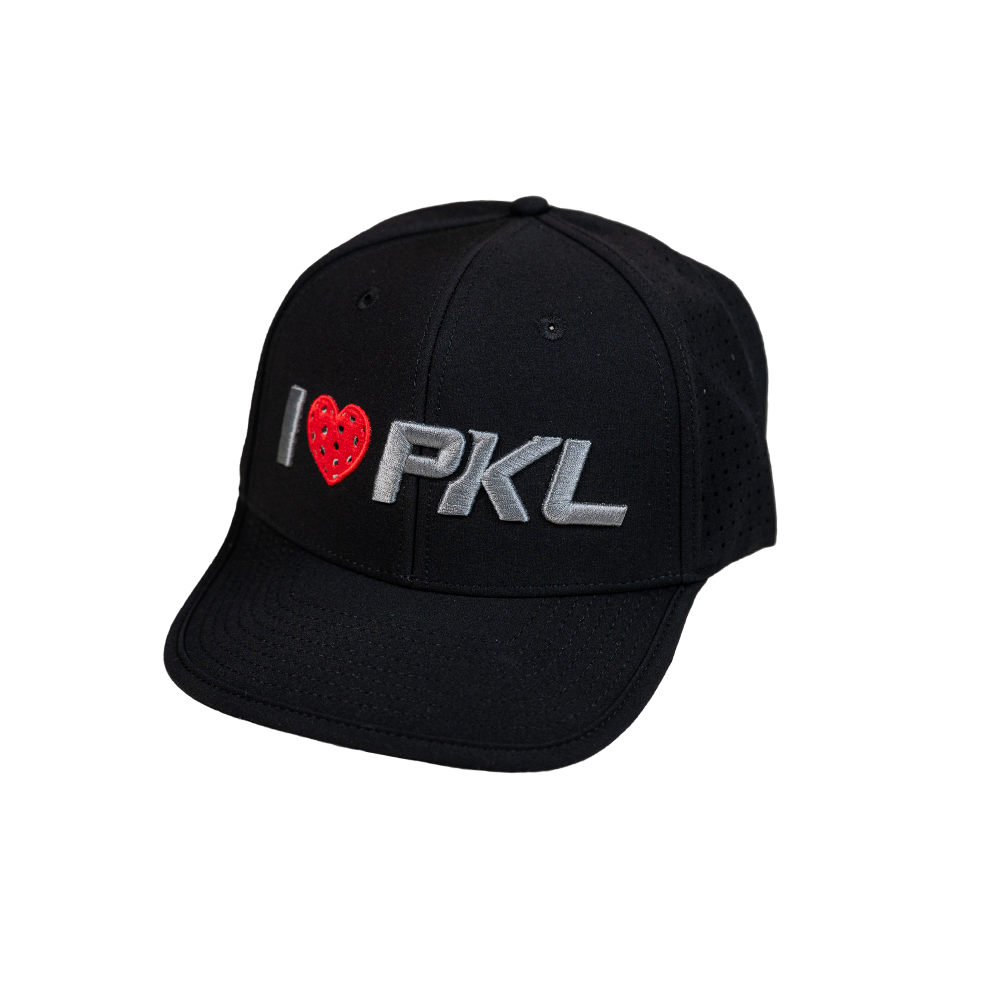 The SEXY Brand I ❤️ Pickleball AquaSnapBack is a black, moisture-resistant hat with “I ❤️ PKL” embroidered on the front—the red heart textured like a pickleball, bold gray “PKL,” curved brim, and perforated side panels.