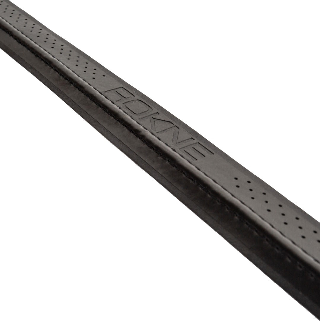 A close-up of the ROKNE REPLACEMENT GRIP by ROKNE highlights its black, perforated textured leather, cushioned build, and strong tack. "ROKNE" is embossed at the center, set against a clean white background.