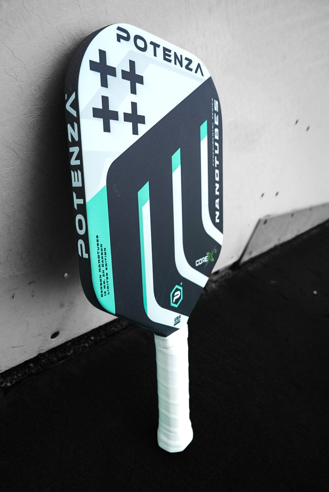 The Potenza Pickleball Carbon Nanotubes+ COREx3 paddle leans against the wall.