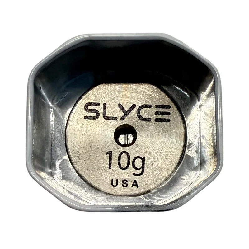 A Slyce Sport SLYCE Adjustable Weighted SpeedCap Slim Edition (21g-36g) Paddle Performance Enhancer sits in a shallow, octagonal silver container viewed from above. The round metal cap is engraved with "SLYCE," weight, and "USA.