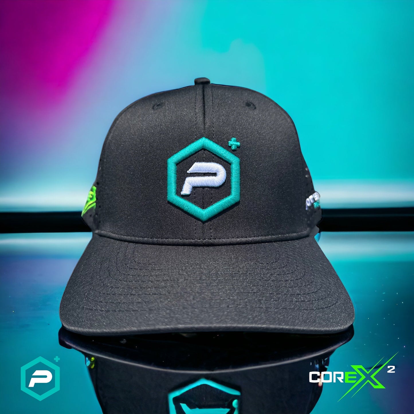 The Potenza Pickleball Performance PRO Hat, Laser Perforated, is a lightweight black cap with a teal and white hexagonal "P" logo on the front, shown on a colorful gradient. COREX² and the logo appear in the image’s bottom corners.