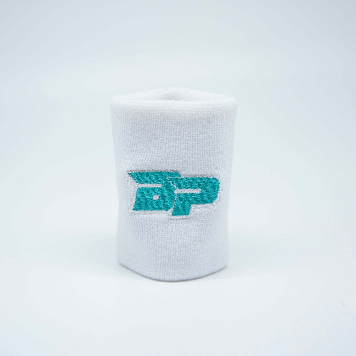 The Bodhi Performance Wristband (1pc) stands upright on a white background, displaying a teal BP logo at the center. Its soft, cylindrical design with smooth edges makes it ideal for workouts or pickleball sessions.