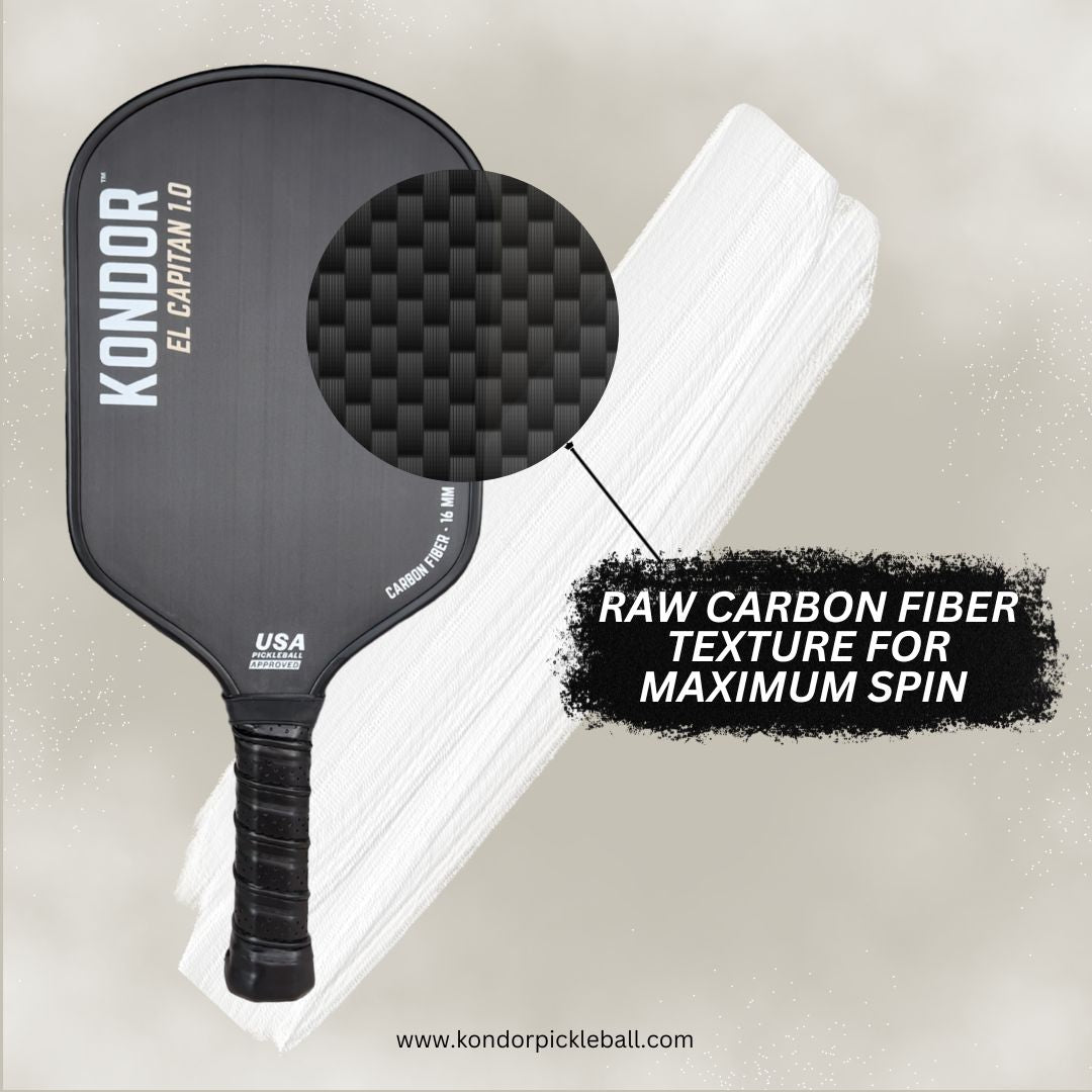 A black El Capitán 1.0 paddle by KONDOR PICKLEBALL rests on a white textured surface. Close-up reveals raw carbon fiber for max spin and a honeycomb core. Text: Raw carbon fiber texture—maximum spin. www.kondorpickleball.com.