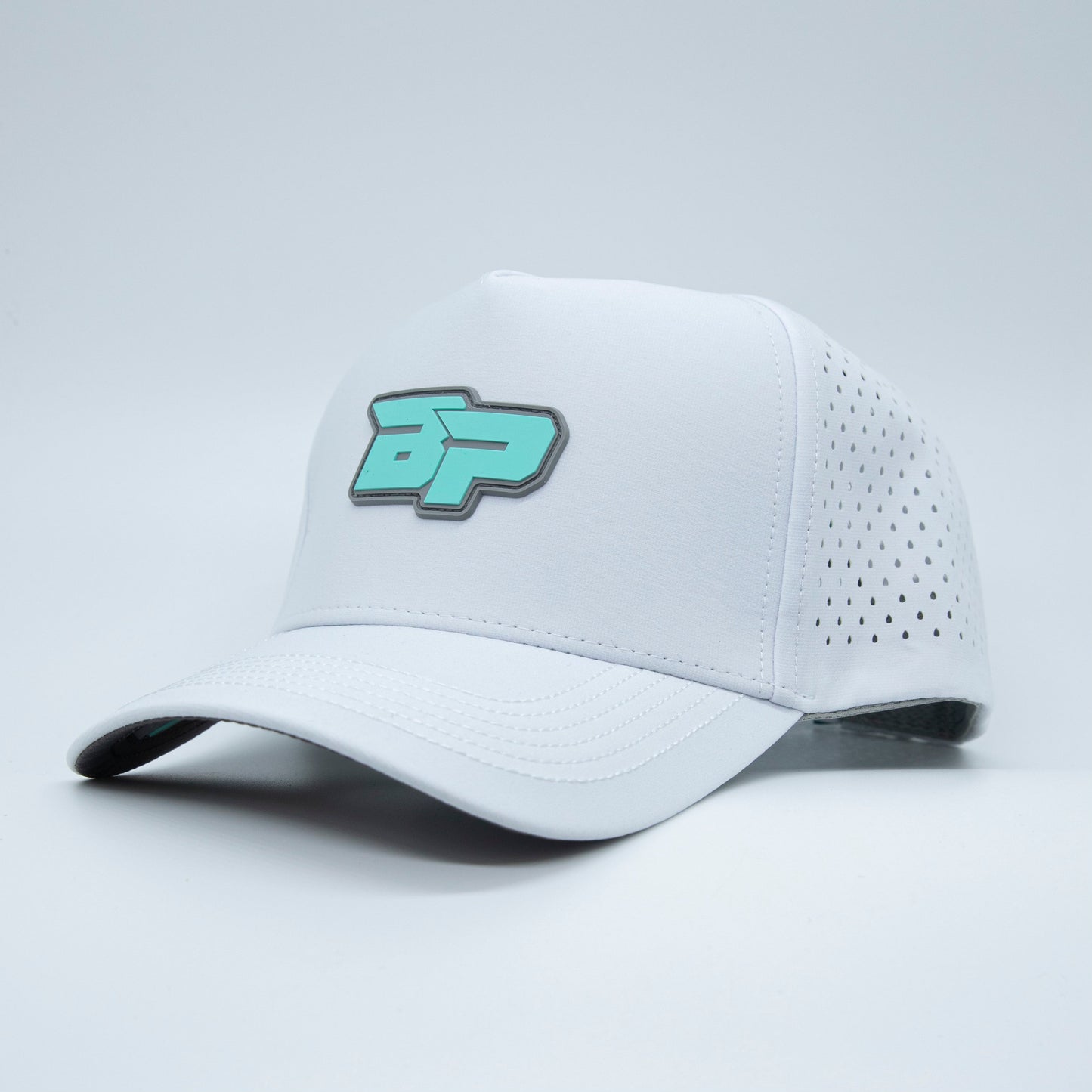 The Bodhi Performance ICON Snapback is a white pickleball hat with a teal and gray embroidered logo on the front and perforated side panels for ventilation, shown against a plain light background.