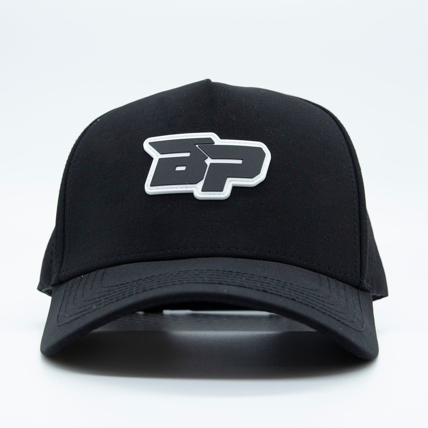 The Bodhi Performance ICON Snapback is a black performance pickleball hat with a curved brim and a bold white and gray BP logo patch on the front, shown against a plain white background.