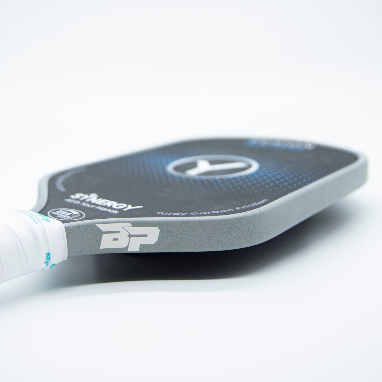 Close-up of a black pickleball paddle featuring Bodhi Performance’s Premium Edge Tape - SOLIDS, with a textured surface, white grip, BP logo on the edge, and blue accents. "Terry Carbon Model" branding shown on a clean white background.