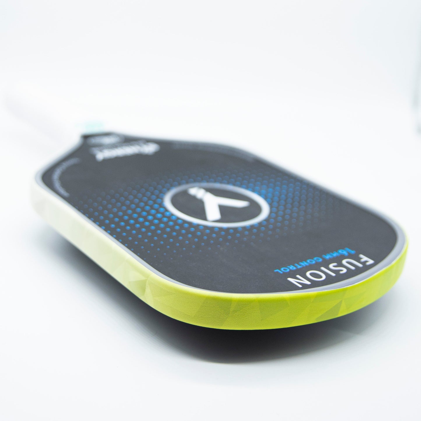 A close-up of Bodhi Performance’s Premium Edge Tape - PATTERNS highlights its bold yellow edge and blue dotted accents on a black paddle, featuring “FUSION” and “TEAM CONTROL,” with a white handle shown against a white background.