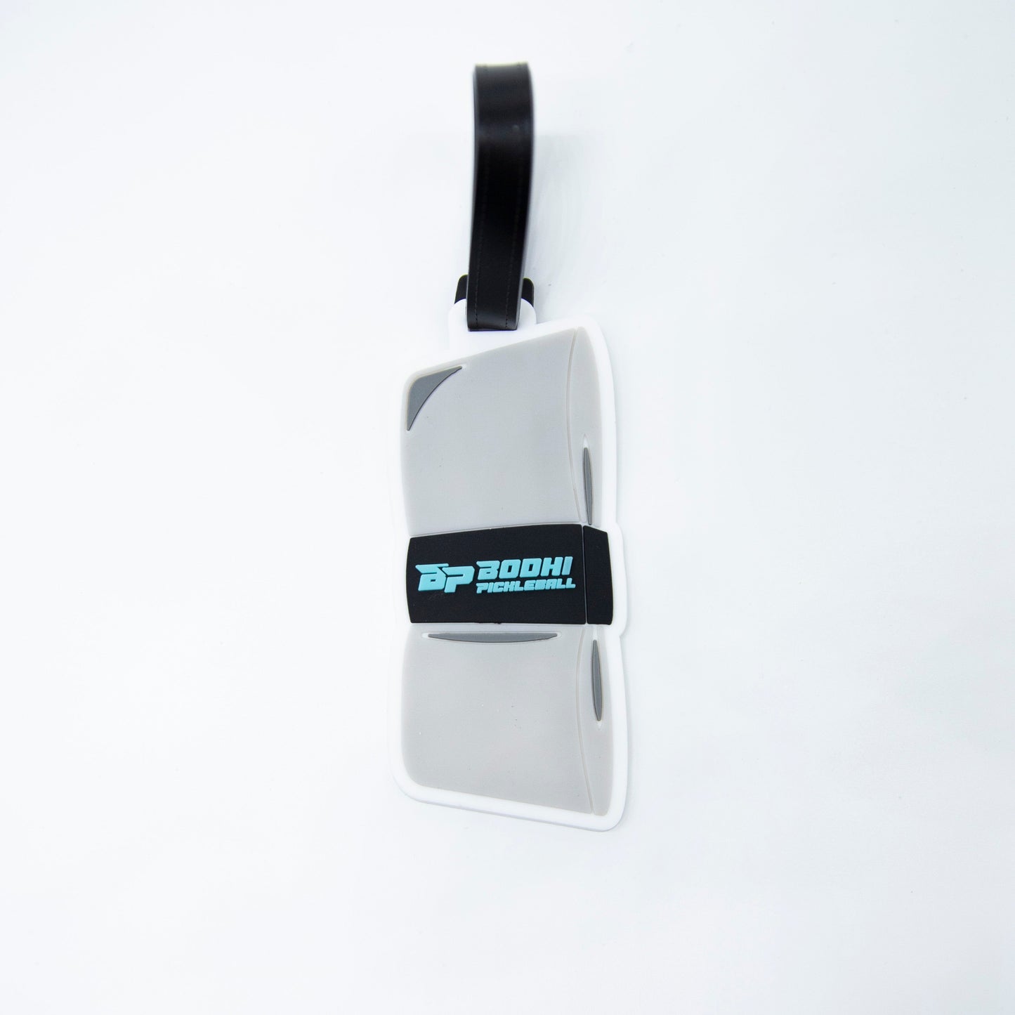 A gray and white rectangular Bodhi Bag Tag by Bodhi Performance with rounded edges, a black strap, and “DP BOOHI PICKLEBALL” on a black band—an essential pickleball accessory for your bag.