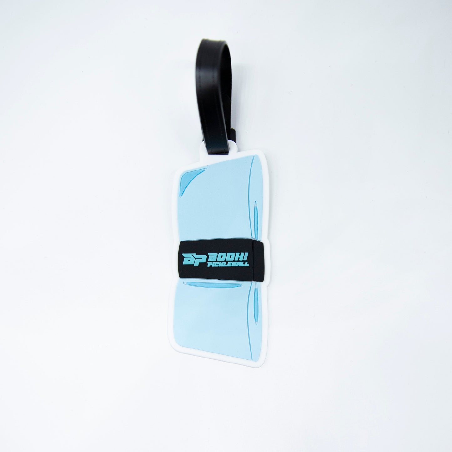 The Bodhi Performance Bodhi Bag Tags feature a light blue design with a black strap and bold “BOOHI PICKLEBALL” text in white and teal on a black band—a stylish pickleball accessory for tournament bags. Plain white background.