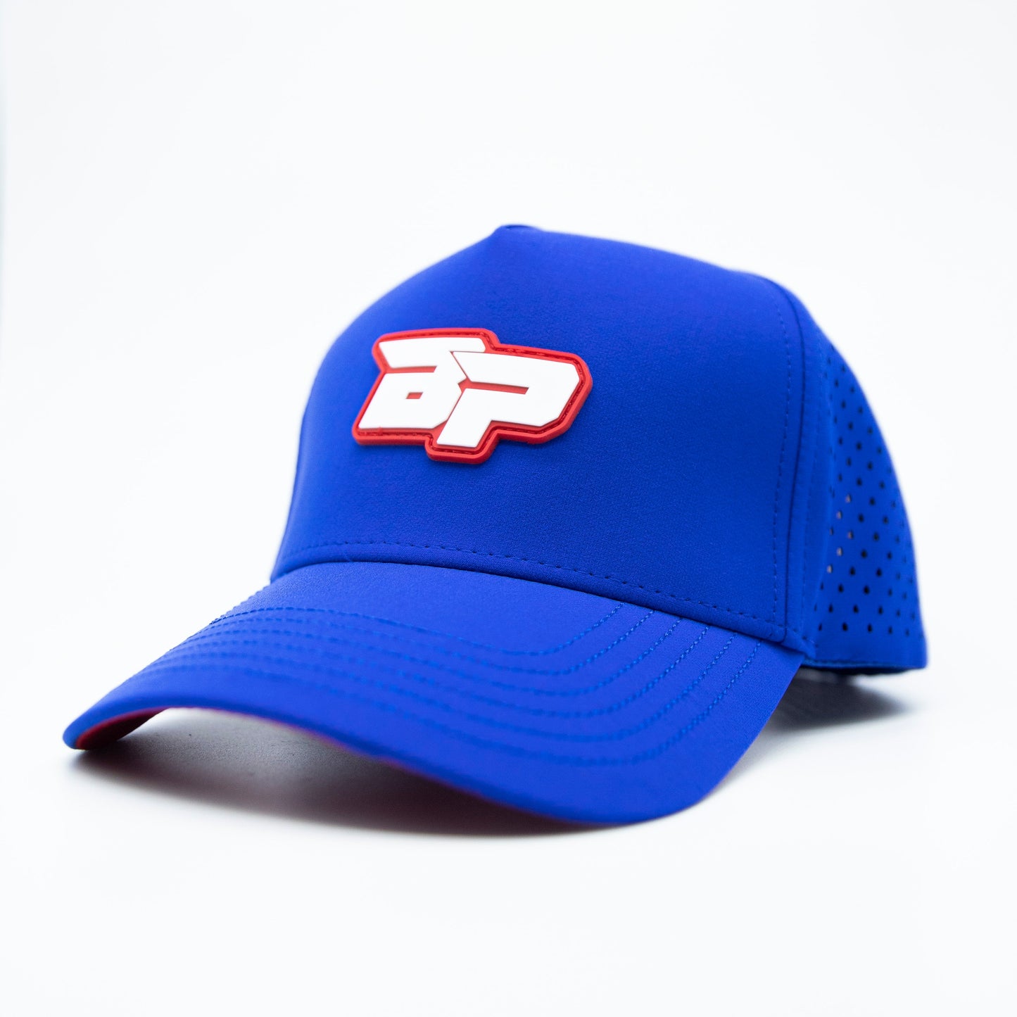 The Bodhi Performance ICON Snapback is a royal blue pickleball hat with a perforated back, stiff curved brim, and bold white and red BP logo outlined in red—a stylish, comfortable choice for standout players.