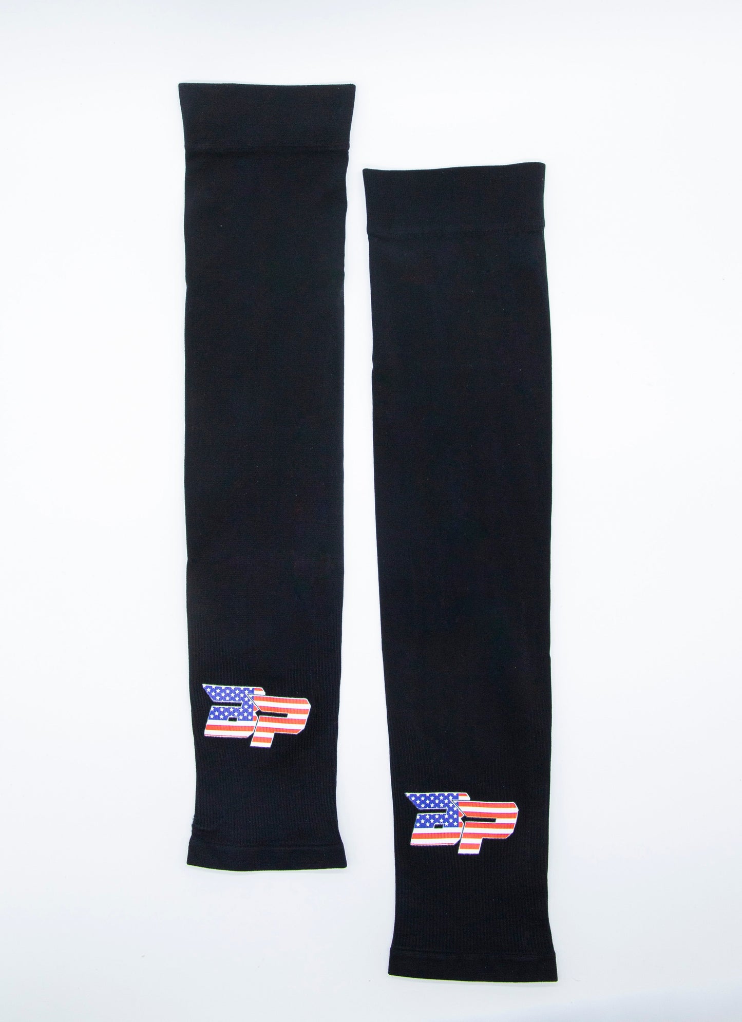 Two Bodhi Performance Arm Sleeves are laid flat on a white background, each featuring a stylized 'P' American flag design. These sleeves provide UV protection and moisture-wicking benefits, ideal for sports use.