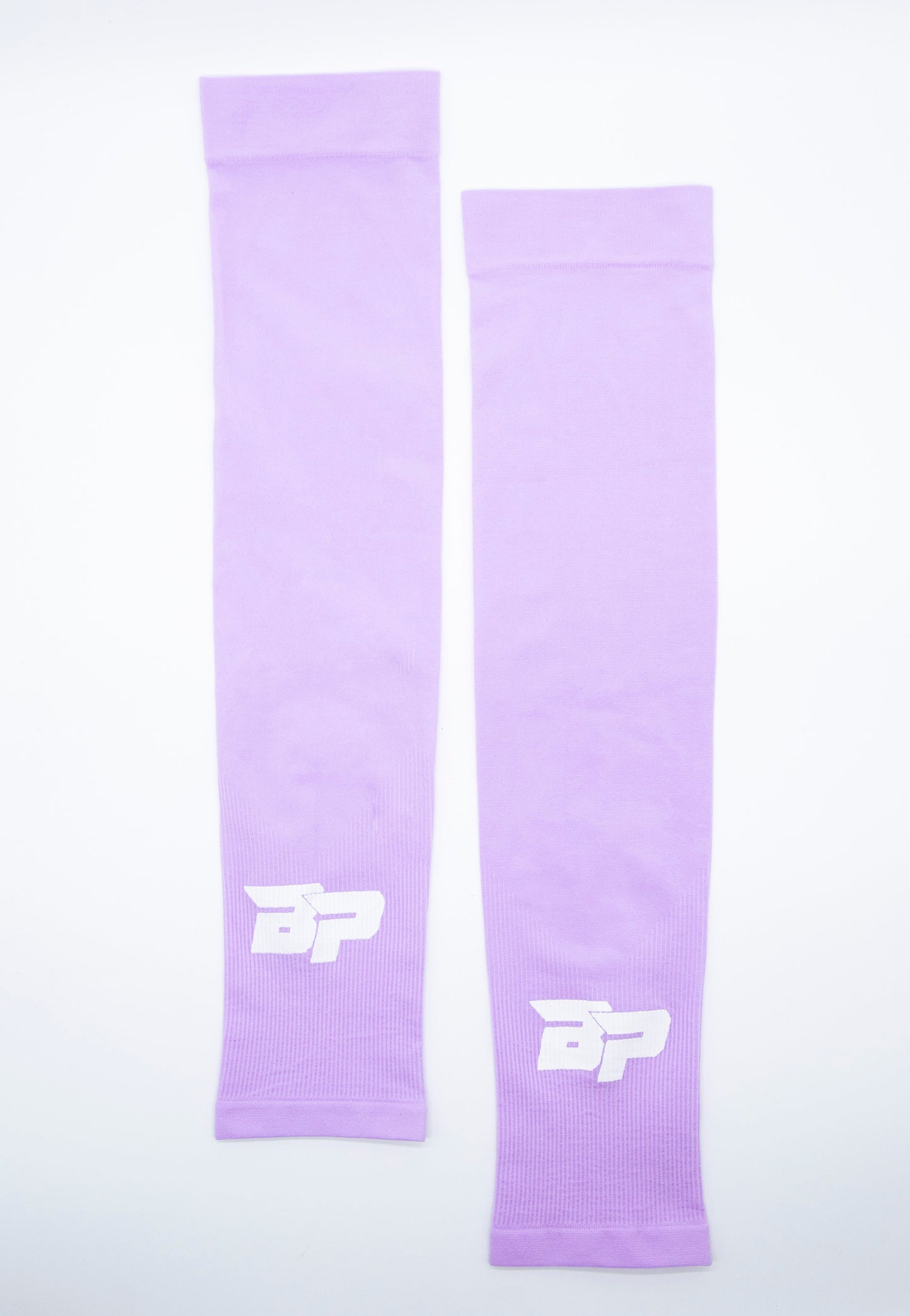 Two lavender Bodhi Performance Arm Sleeves are laid flat side by side on a white background. Each features a bold white BP logo near the wrist, made of smooth, stretchy fabric ideal for sports comfort and support.