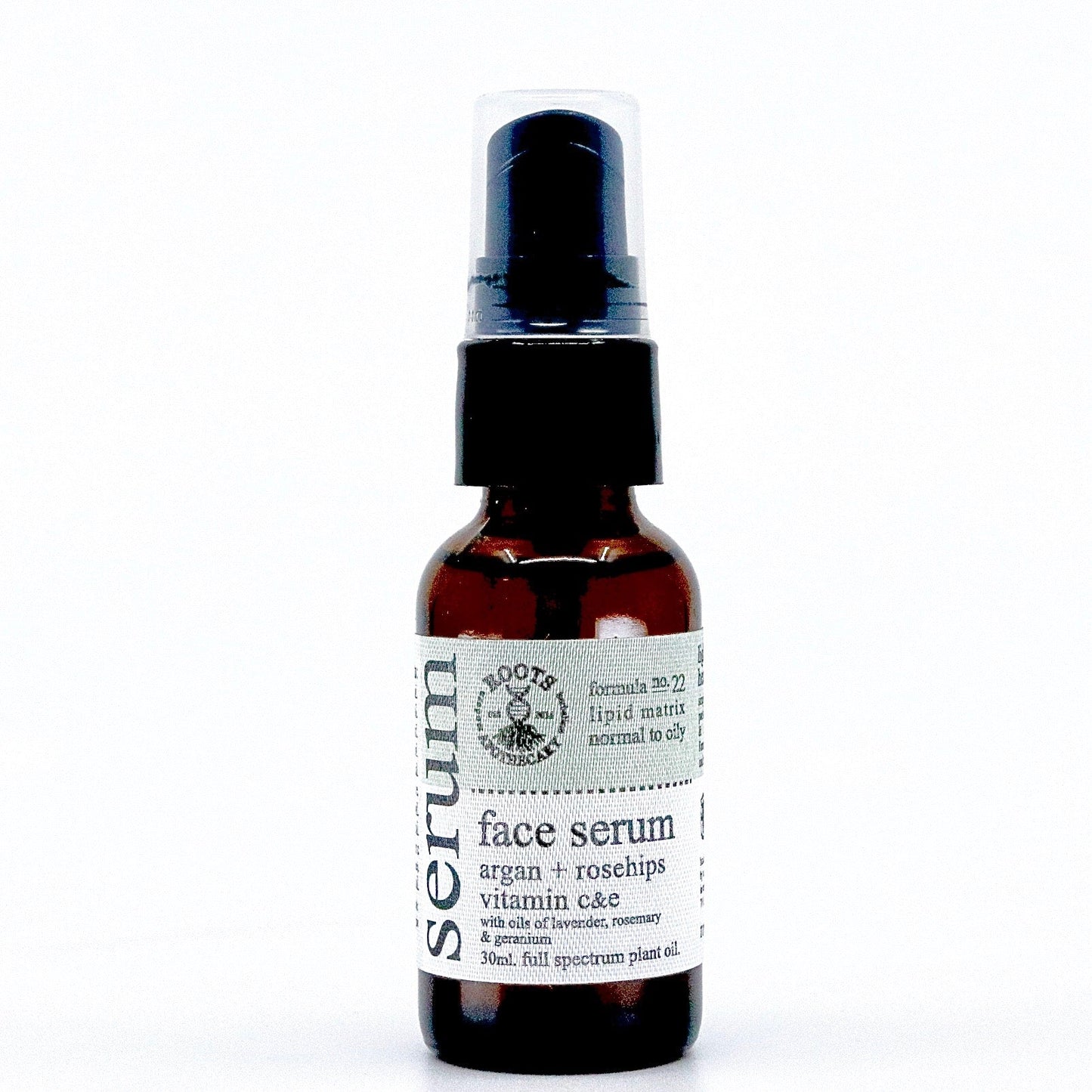 A small brown glass bottle with a black pump dispenser, Roots Apothecary face serum blends unrefined argan oil, rosehips, vitamin C moisturizer, and full spectrum plant oils for normal to dry skin. White label with black text.