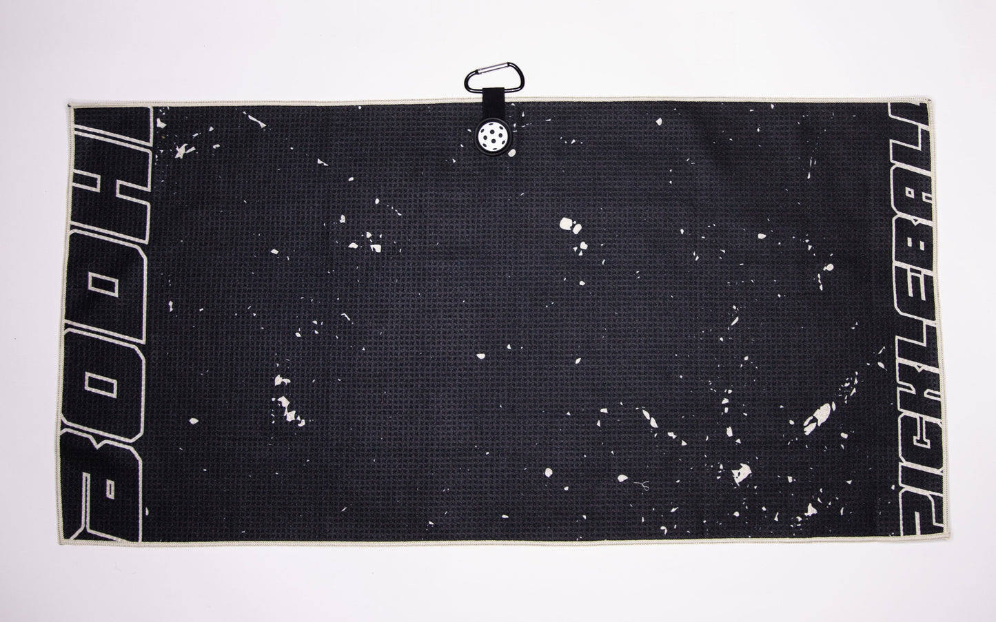 The Bodhi Performance Pickleball Towel is a rectangular black microfiber towel with white speckles, bold PICKLEBALL text on the edges, and a black carabiner clip—perfect for any pickleball player’s gear.